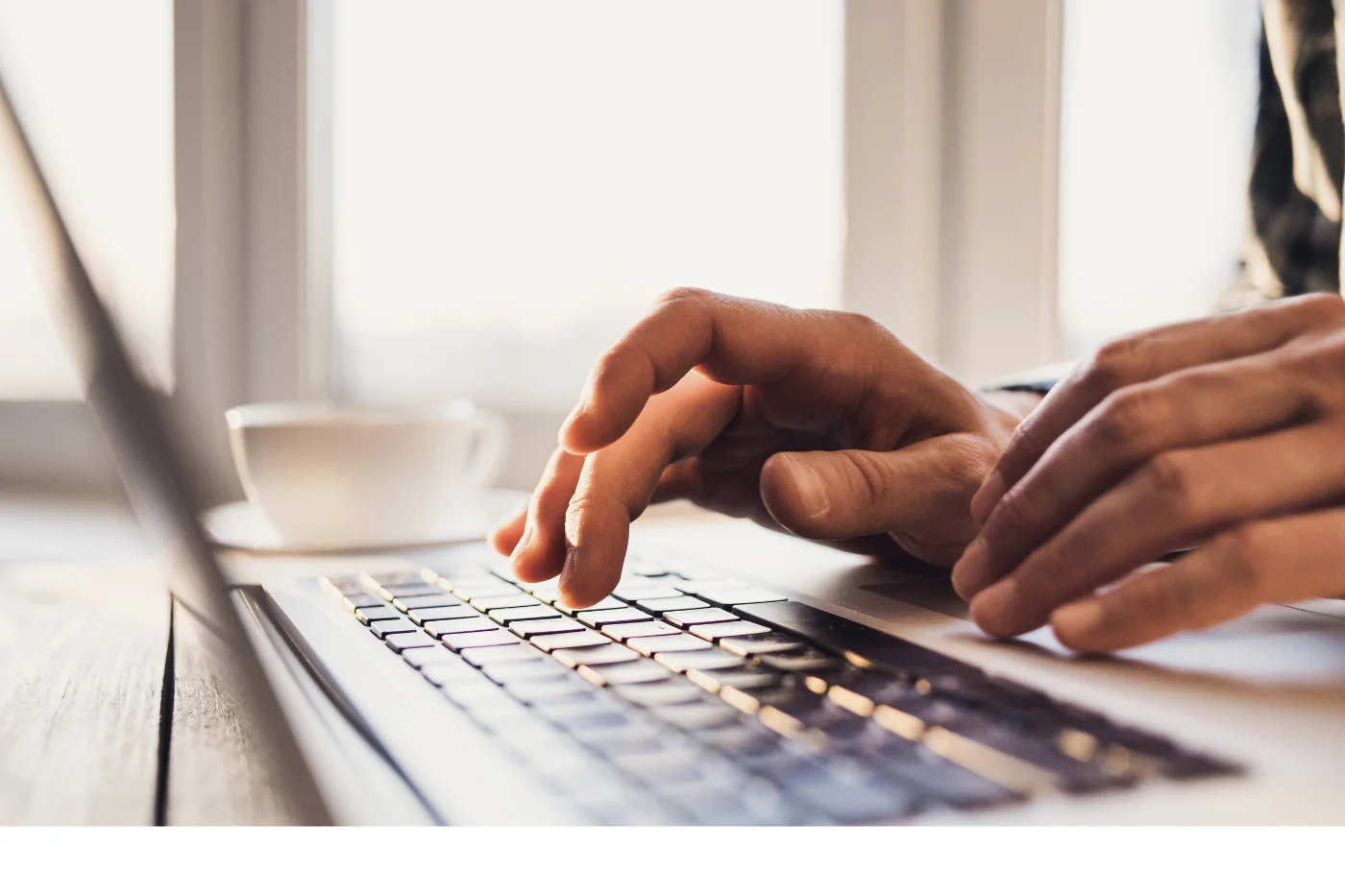 Hands typing on laptop — writing website copy